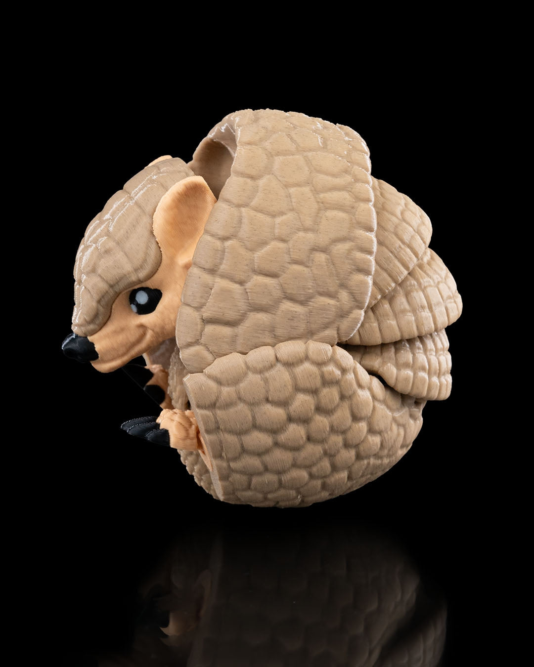 3D-printed Armadillo figurine, curled ball pose, face detail visible